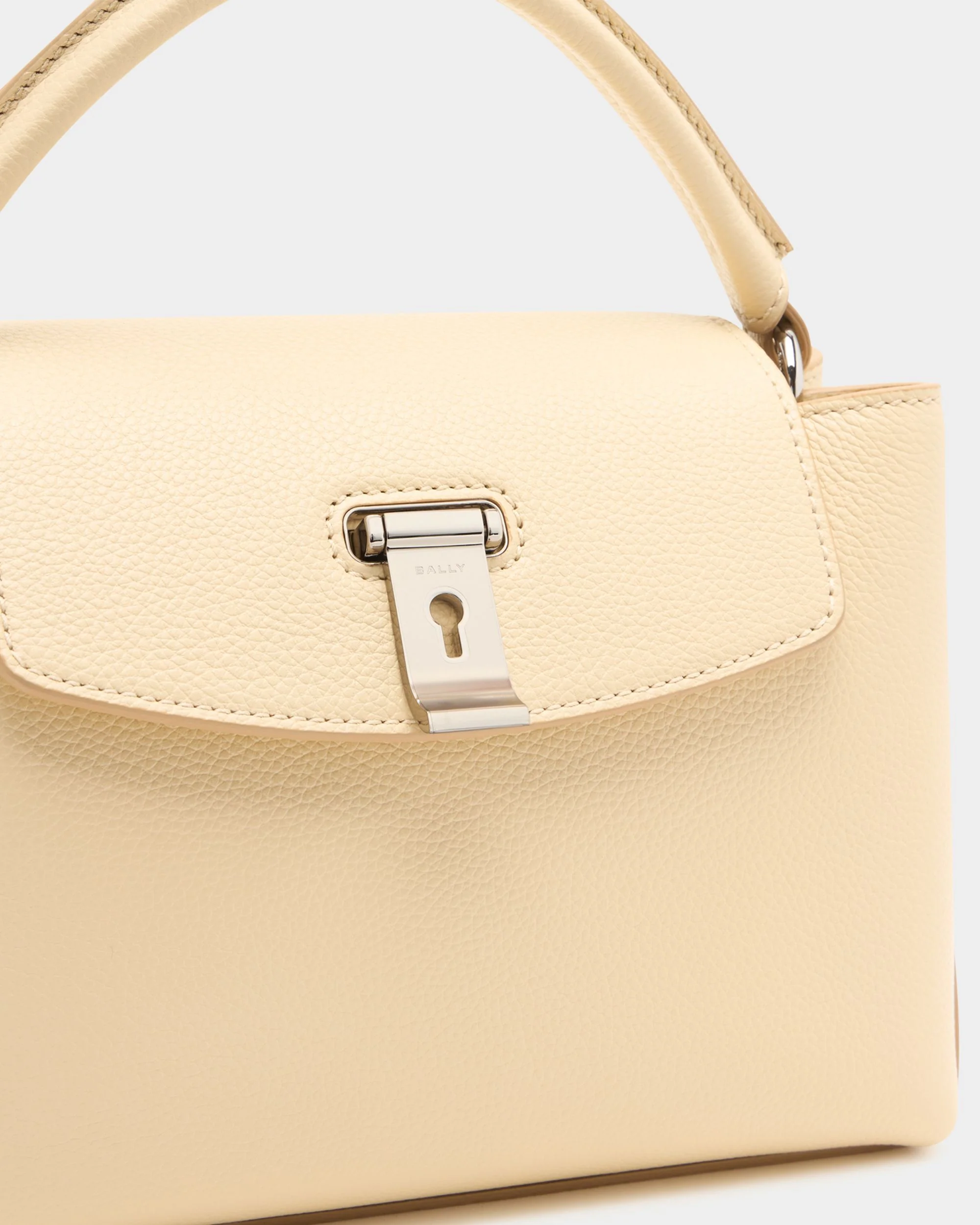 Lock Me Small Top Handle Bag in Ginger Grained Leather - Image 6